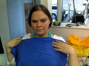 A picture of me holding a bright blue fabric sample 