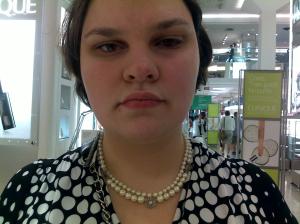 A picture of me wearing another multistrand necklace, this one with three or four silver flowers placed at intervals along the front.