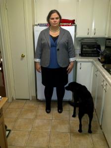 A picture of me in a black pencil skirt, black lace-trimmed camisole, low-cut teal top and grey blazer with contrast cuffs. I'm wearing a tripple-strand of pearls tied in a knot with the outfit. 